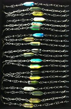 a box filled with lots of different types of fishing lures on chain link bracelets