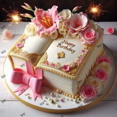 a birthday cake decorated with flowers and an open book