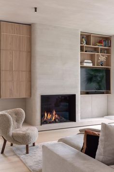 a living room with a couch, chair and fire place