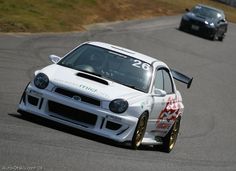 two cars driving on a race track near each other