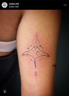 a woman's arm with a tattoo on it that looks like a starfish