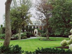 a large house surrounded by trees and bushes