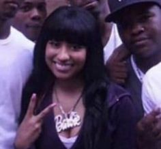 a group of young people standing next to each other with one woman giving the peace sign