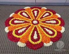 an orange and red flower is on the floor