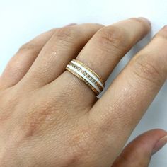 a woman's hand with two rings on it