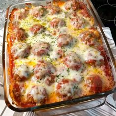 a casserole dish with meatballs and cheese