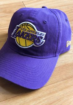 This Los Angeles Lakers Purple Adjustable Hat features a team logo embroidered on the front. Team logo embroidered on the front, Cloth Strap Closure to dial in the perfect fit, Relaxed, unstructured fit, Pre-curved bill, 100% cotton construction, New Era Flag logo on side, Dad hat, 100% Cotton, Washable, Imported Dad Cap With Embroidered Logo For Fan Gear, Adjustable Dad Hat With Embroidered Logo For Fans, Sporty Cotton Snapback Hat For Fans, Cotton Sports Fan Hat, Team-colored Cotton Hat With Embroidered Logo, Team-colored Cotton Hats For Sports, Team-colored Cotton Sports Hats, Sports Cotton Hat With Logo, Cotton Sports Hat With Logo