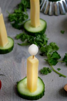 cucumber and cheese appetizers with toothpicks in them on a table