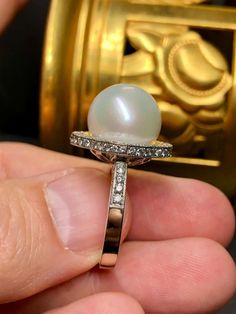 For Sale on 1stDibs - An elegant and timeless ring done in 18K white gold centered by a cream colored 13.4mm large South Sea pearl with very minor pitting and a beautiful, even Luxury White Pear-shaped Diamond Ring, High Luster Round Cut Rings For Formal Occasions, Formal Round Cut High Luster Rings, Formal High Luster Round Cut Rings, Luxury Brilliant Cut Diamond Pearl Ring, Luxury Pearl And Diamond Ring With Brilliant Cut, Timeless White Gold Pearl Ring With Diamonds, Luxury Brilliant Cut Pearl Anniversary Ring, Formal Brilliant Cut Pearl Ring In Platinum