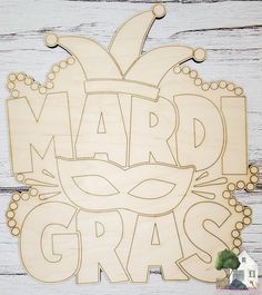 a wooden sign that says mardi gras