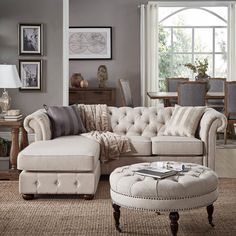 a living room filled with lots of furniture and decor on top of carpeted flooring