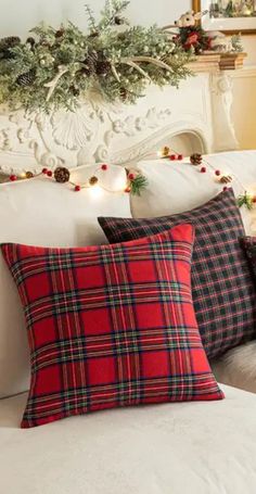 christmas decorations on the headboard of a bed with red and black plaid pillow cases