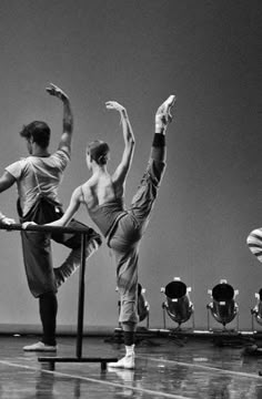 three men are doing ballet moves on the stage