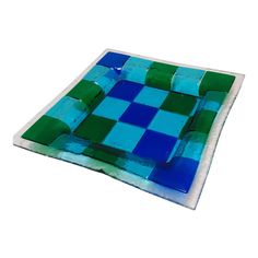 a blue and green glass plate sitting on top of a table