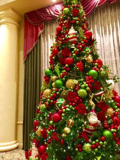 a christmas tree decorated with red, green and gold ornaments