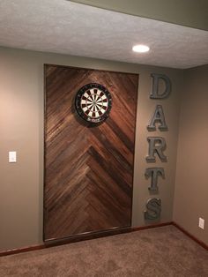 a dart sign mounted to the side of a wall next to a darts door