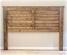 the headboard is made out of wooden planks