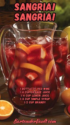 sangrija sangria with orange slices and sliced strawberries in pitcher on table