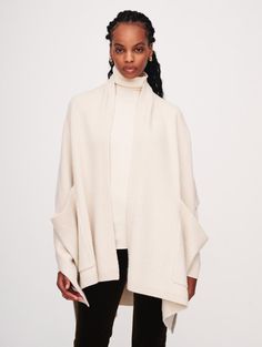 Front view of a woman wearing the Ivory Cashmere Blend Open Poncho by White + Warren Oversized Cream Cashmere Outerwear, Oversized Cashmere Cape With Long Sleeves, White Wrap Outerwear For Fall, Oversized Long Sleeve Beige Cape, Oversized Beige Wrap Outerwear, Chic White Cape For Fall, Chic Oversized Shawl Outerwear, Oversized White Cape Outerwear, Oversized Cream Cape For Fall