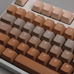 a computer keyboard with brown keys on it