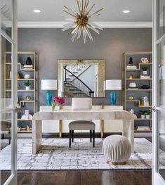 an elegant dining room with gray walls and white furniture