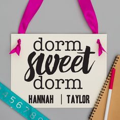 a sign that says dorm sweet dorm on it next to a ruler and pencils