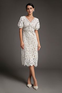 This lace crochet V-neckline midi dress will fill any of your little white dress needs, from your bridal shower to your after party. The textured lace overlay, accented with thick embroidery that outlines the lace’s blooms. Also features puff sleeves and delicate scalloped eyelash lace hem. The rhinestone trim and buttons adds an extra glitz and glam. No Stretch Medium Weight Size runs small,recommend one size up Fabric: 100% Polyester,Lining: 100% Polyester Model is 174cm/5'7" tall, 81cm/32" bust, 61cm/24" waist and 90cm/35" hip and wears a size S. Care Instruction: Hand Wash, Do not bleach, Dry flat in shade, Iron cool (max 110â„?, Dry clean, tetrachloroethylene(PCE) only.Please note: The images represent actual product though color of the image and product may slightly differ. This item Thick Embroidery, Modest Midi Dress, Vintage Dress Design, Little White Dress, Cap Dress, Rhinestone Trim, Korean Dress, Lace Crochet, Lace Hem