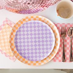 a place setting with pink and orange plates