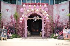 the entrance to an event decorated with pink and gold decorations