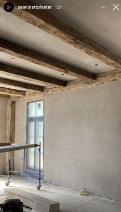 an empty room with unfinished walls and beams