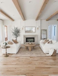 a living room filled with furniture and a fire place in the middle of a room