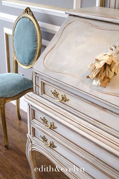 an antique desk with a chair and mirror