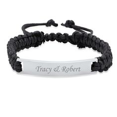 a black rope bracelet with an engraved bar on it