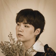 a young man holding a bouquet of flowers