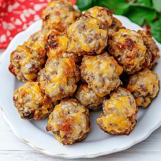 a white plate topped with meatballs covered in cheese