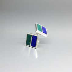 "Malachite and Lapis Lazuli square green and blue stud earrings with silver. Unique gift for her or him, friend, girlfriend, wife, September and October birthstone, 9 year anniversary. Modern and minimal square earrings combining blue Lapis with green Malachite. This beautiful earrings are worked with the technique of inlay, which means the stone is worked seamlessly into the Sterling silver. Each earring is divided into to rectangle parts divided by a 1mm silver line.  Our silver is Sterling silver and nickel free. All our stones are natural stones and our jewelry is handmade, slight differences in color and size may occur. Our inlay work is made with real stone and NOT stone dust. Please note the size specifications!  Earring size: 11 x 11 x 2 mm stone size per rectangle: 11 x 5 mm weigh