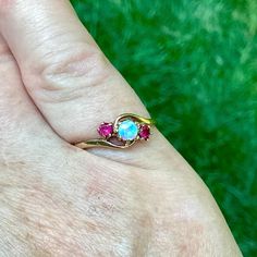 Vintage 9K gold gemstone trilogy stacking ring, opal & 2 rubies, US size 7 1/2, dainty colourful, Classic, OOAK unique gift for her wife mom. Such a colourful ring! I really like the classic combination of opals and rubies. This beauty comes with a set of full British hallmarks for authenticity. The gemstones are set in an attractive asymmetrical "bypass" style. The opal measures 4mm and the rubies each measure 3mm. Kindly message me for resizing options. Your ring will arrive in a unique OOAK a Three Stone Opal Ring Gift, Gift Yellow Gold Three Stone Opal Ring, Yellow Gold Three Stone Opal Ring Gift, Ring Opal, Ceylon Sapphire, Junk Drawer, Unique Gifts For Her, Three Stone Rings, Color Ring