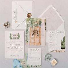 the wedding stationery is laid out on top of each other, including an envelope and two