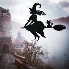 a silhouette of a witch riding a broom on top of a castle