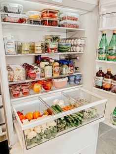 a refrigerator filled with lots of food and condiments on it's shelves