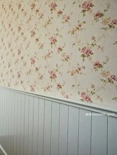 an empty room with floral wallpaper and wooden flooring on the walls is shown