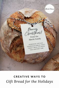 a loaf of bread sitting on top of a table next to a tag that says creative ways to gift bread for the holidays