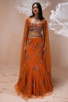 Burnt orange net mermaid lehenga with an attached cancan and floral motifs, sequins and zari hand embroidery. Comes with a padded blouse and dupatta. - Aza Fashions Holud Outfit, Organza Gown Designs, Hand Embroidery Lehenga, Mermaid Lehenga, Drape Lehenga, Fusion Dress, Fashion Course, Orange Lehenga, Organza Gown