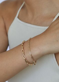 She is ready to be bold without the bulk. Designed to be a building block, where you can wear it alone, or layer them with our Kyle Figaro Chain Bracelet, or the Capri Curb Chain Bracelet. Comes in 1 chain (model wearing 2 chains in photos) 14k solid gold - always Chain comes in 7", and is self-adjustable The bracelet weighs about 2.5grams Link size: 9mm x 3mm Photos showing 3 different sizes: Micro, Petite, Mini (top to bottom) Need a custom size? Email us at hey@kinnstudio.com Luxury Modern Paperclip Bracelet, North Star Necklace, Link Chain Bracelet, Broken Chain, Domed Ring, Yellow Gold Chain, Madewell Jeans, Pearl Charms, Fine Jewelry Collection