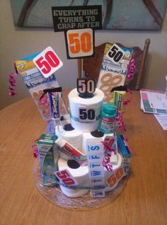 a birthday cake made to look like a pile of toilet paper and some other items