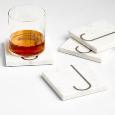 marble coasters with drinks in them on a white surface