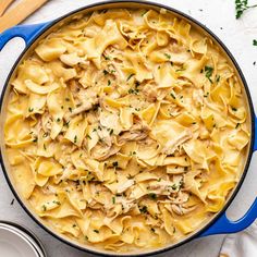 a blue pot filled with pasta and chicken