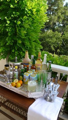 an outdoor bar set up with drinks and liquor