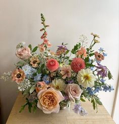 a vase filled with lots of different colored flowers