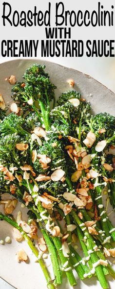 roasted broccoli with creamy mustard sauce on a white plate topped with almonds